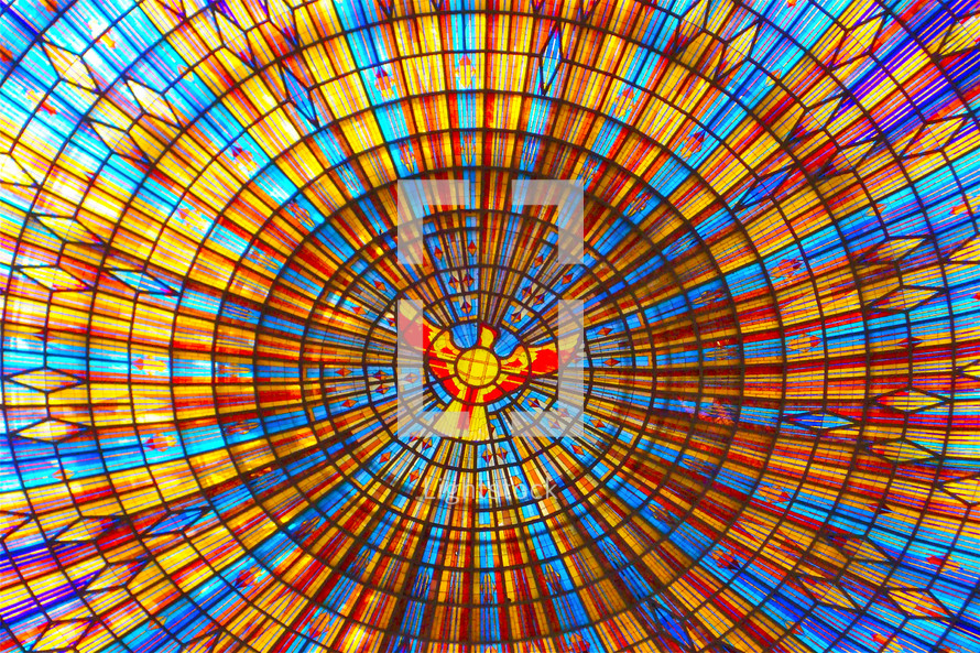 Colorful church stained-glass window with a dove in the center. The Basilica of Our Lady of Peace.