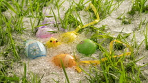 Snow melt in green grassy meadow with colorful painted Easter eggs and cute chick decoration Time-lapse
