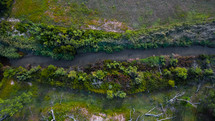 Aerial shot of creek basin and dead trees in Northwest Oklahoma.