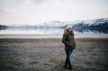 a woman standing by a lake shore in Washington 