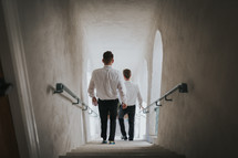 groomsmen walking down a stairwell 