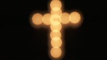 bokeh candlelight in the shape of a cross 