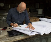a man working on blueprint plans 