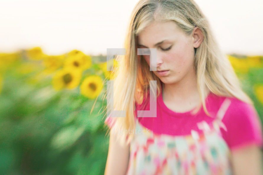 Young girl in sunflower field