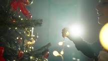 Kid Lighting a Christmas tree for holidays 