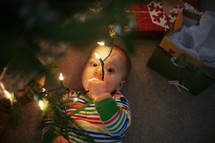 Baby playing with Christmas lights