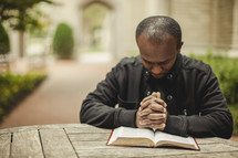 Man in prayer with bible