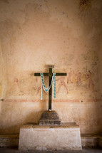 ancient cross and faded paintings in an old church 