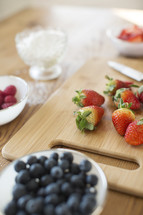 berries in bowls and on a cutting board 