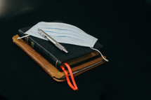 journal, Bible, pen, and face mask 