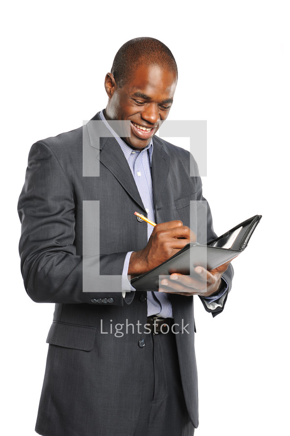 businessman writing in his event calendar 