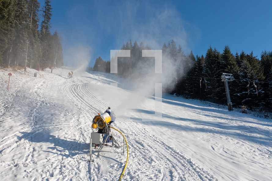 Snow blowers on a ski slope