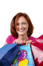 woman holding gift bags of birthday presents 