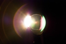 Shure microphone with stage light lens flare.