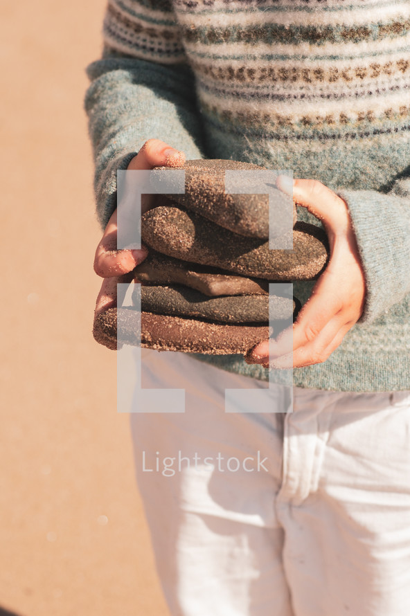 child holding rocks 