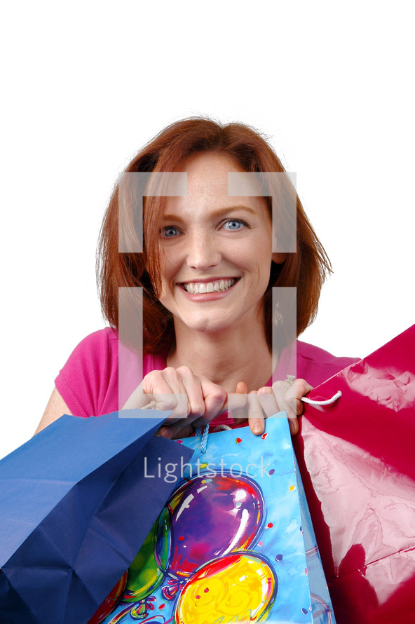 woman holding gift bags of birthday presents 