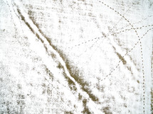 aerial view over tracks in snow 