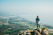A girl looking down at Galilee from the top of Mount Arbel in Israel