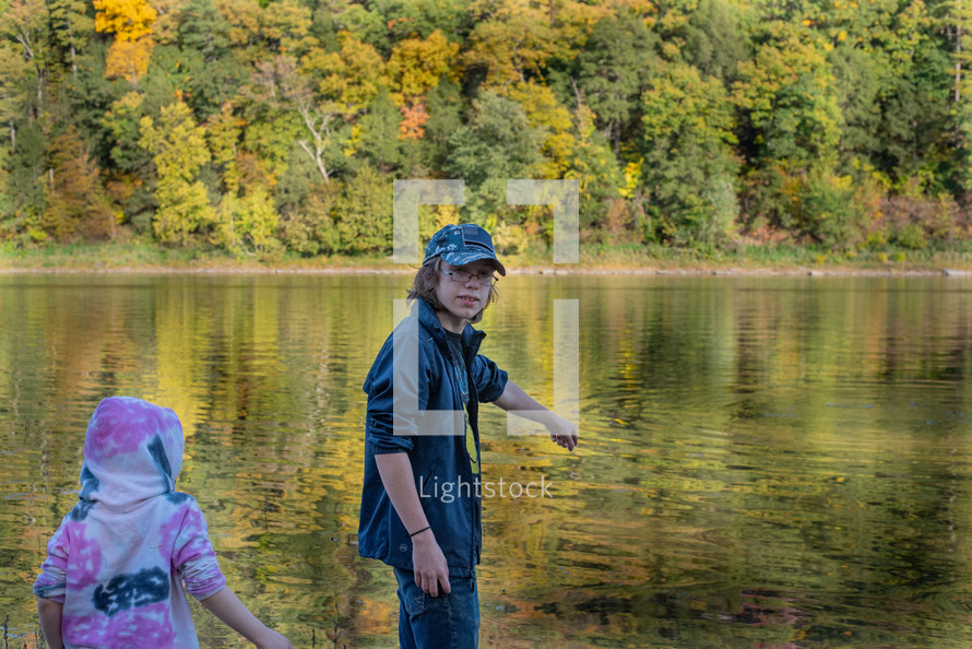 Kids playing by the water in the fall