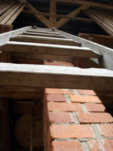 a ladder to the upper floor of a stable