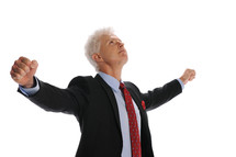businessman holding his hands up in victory 