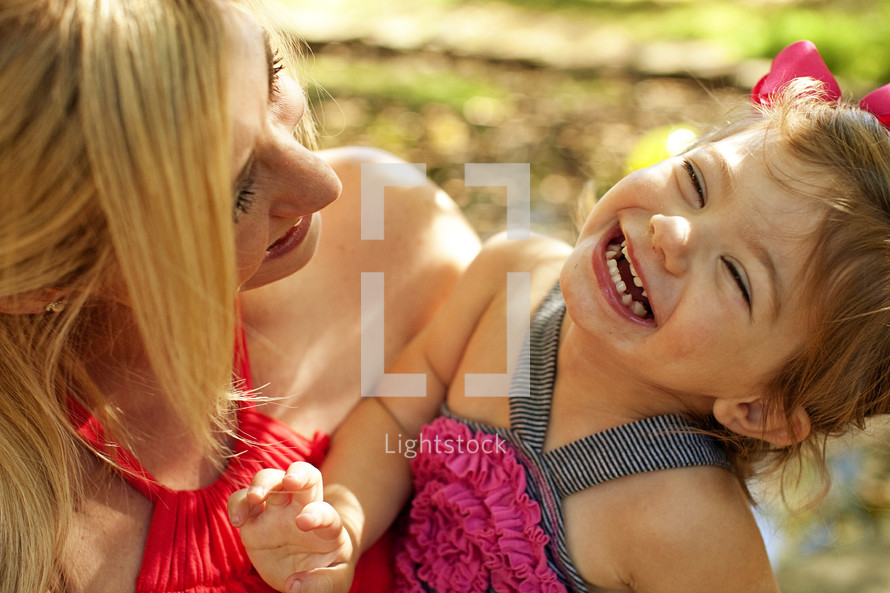 A mom and laughing daughter