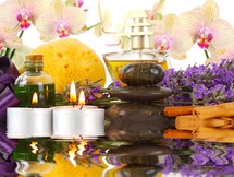 Accessories for spa with orchids, lavender, stones, sponge, candles and cinnamon.