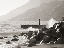 Fisherman while fishing on the rocks of Maiori, Amalfi Coast. Italy