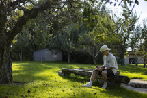 Man reading on a bench in the park