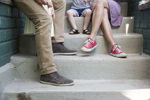 a family sitting on front porch steps 