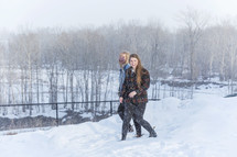 two young adults out in snow having fun