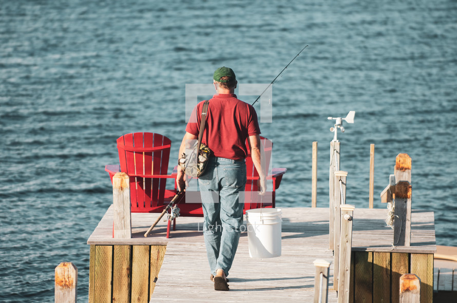 a man with a fishing pier on a dock 