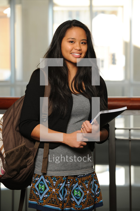 college student holding a notebook 