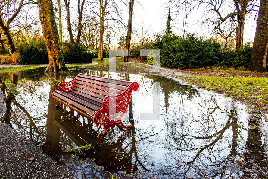 park bench in a puddle 