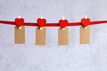 red hearts and felt tags on a clothesline 