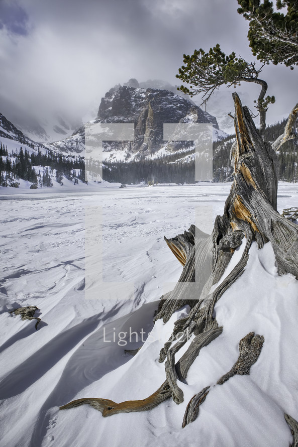 Winter winds and frozen alpine lakes at a popular hiking destination called The Loch Vale in Rocky Mountain National Park
