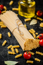 A pile of spaghetti dry on the table. Against a dark background. High quality photo