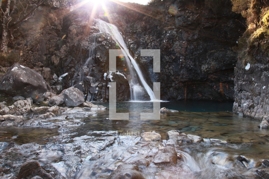 sunlight over a waterfall 