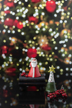 Small Ceramic Santa and Christmas Tree with Christmas Tree in Background