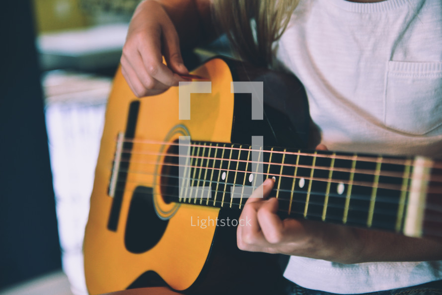 girl playing a guitar 