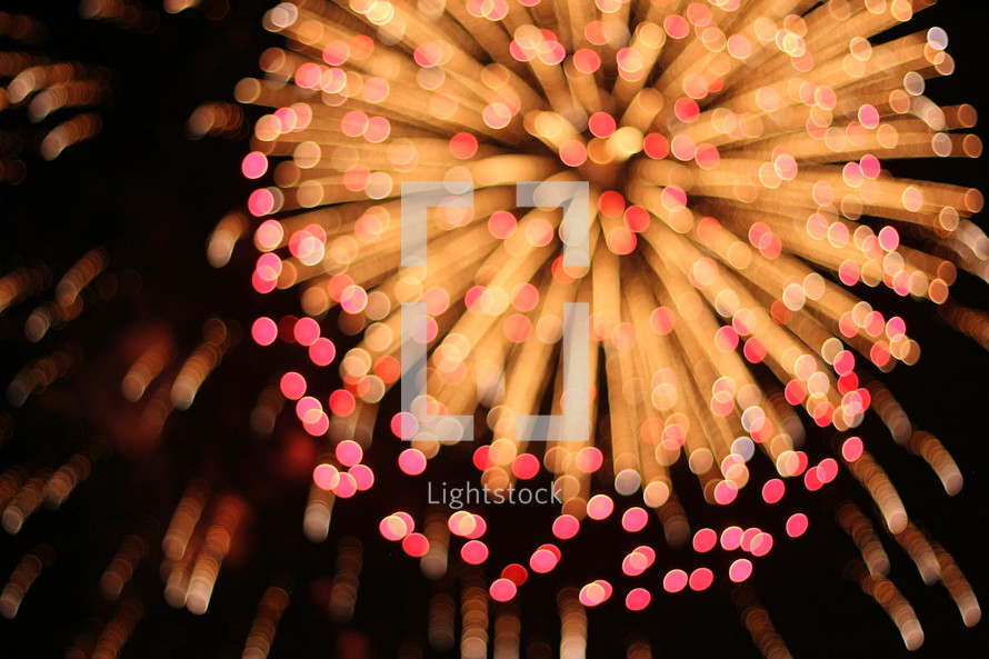 pink and yellow fireworks bursting 