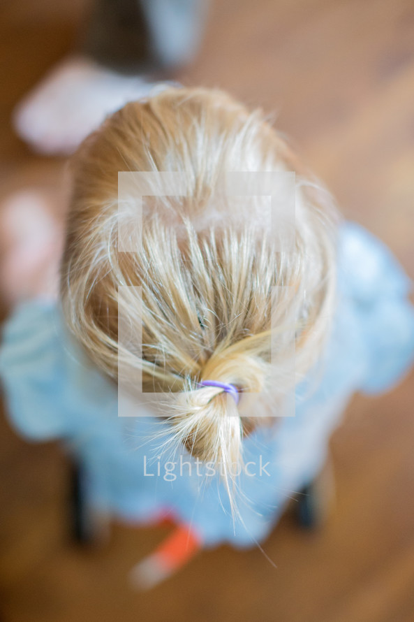 top of toddler's head with a little pony tail 
