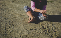 girl playing in dirt 