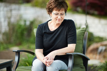 a woman sitting outdoors relaxing 