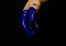 a hand dipped in blue paint 