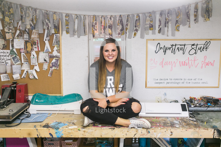 young woman sitting in a craft room 