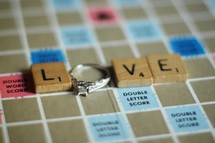 Love out of scrabble pieces and an engagement ring 