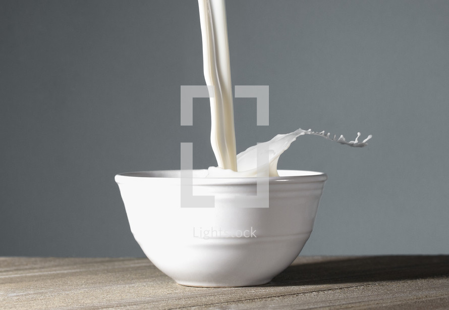 A Bowl of MIlk Being Poured and Splashing Out