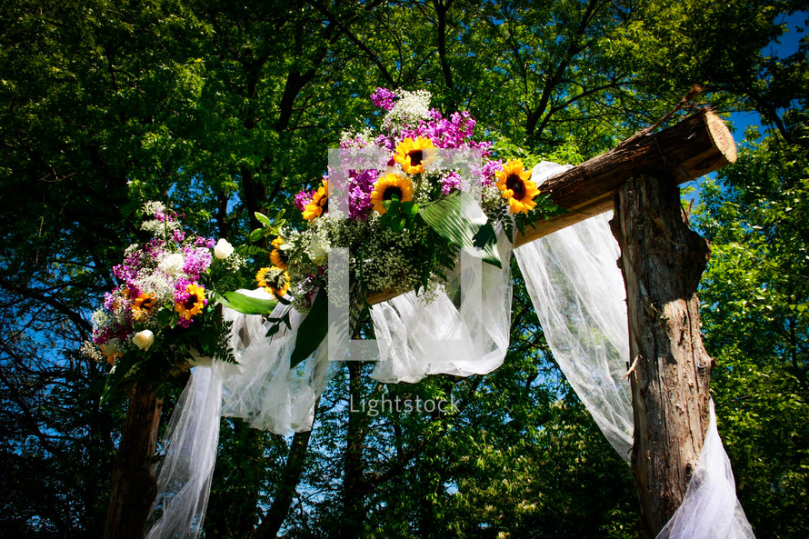 flowers on an archway for an outdoor wedding 