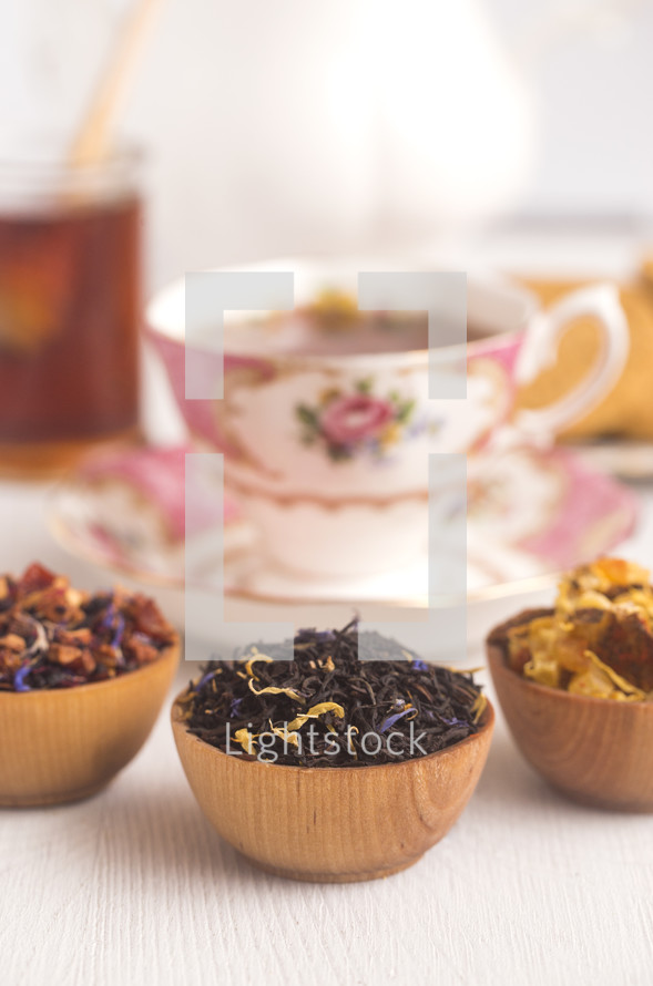 Loose Leaf Tea in a Wooden Bowl, tea cup, and honey 